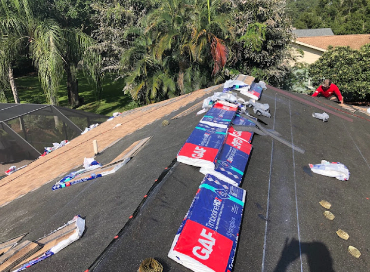 beige roofing with a dark grey tile roofing and some gaf cardboard on top